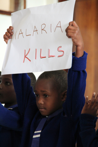 Child holding malaria kills poster