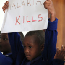 Child holding malaria kills poster